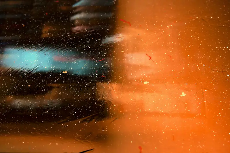 Sparks of light drifting over an orange blur